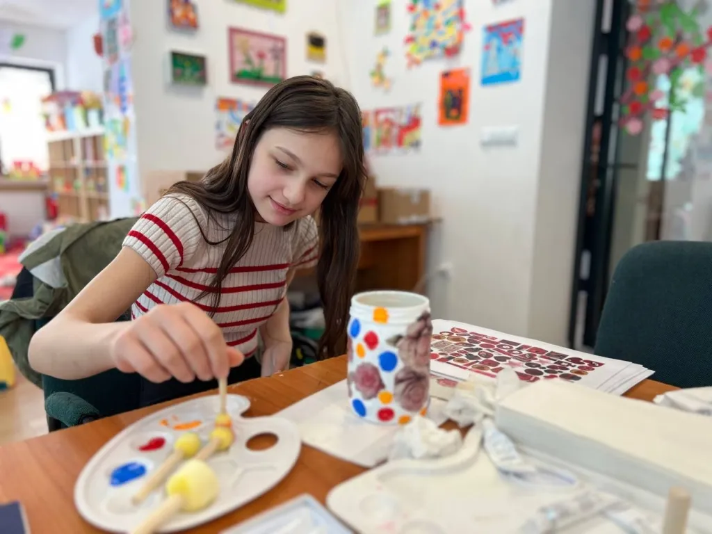 young girl paints